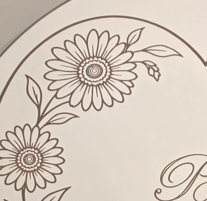 Mirror engraving detail showing the floral heart with pink colouring