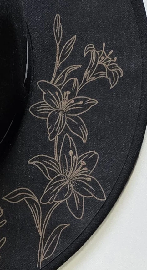 Engraved felt hat detail: fine floral lines on the brim for The Fireflies