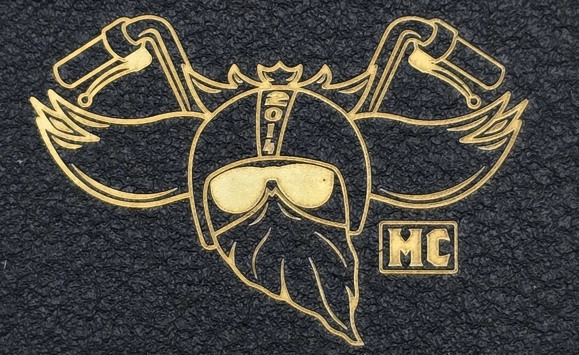 Engraved Zippo detail showing brass-coloured logo lines beside the black textured coating