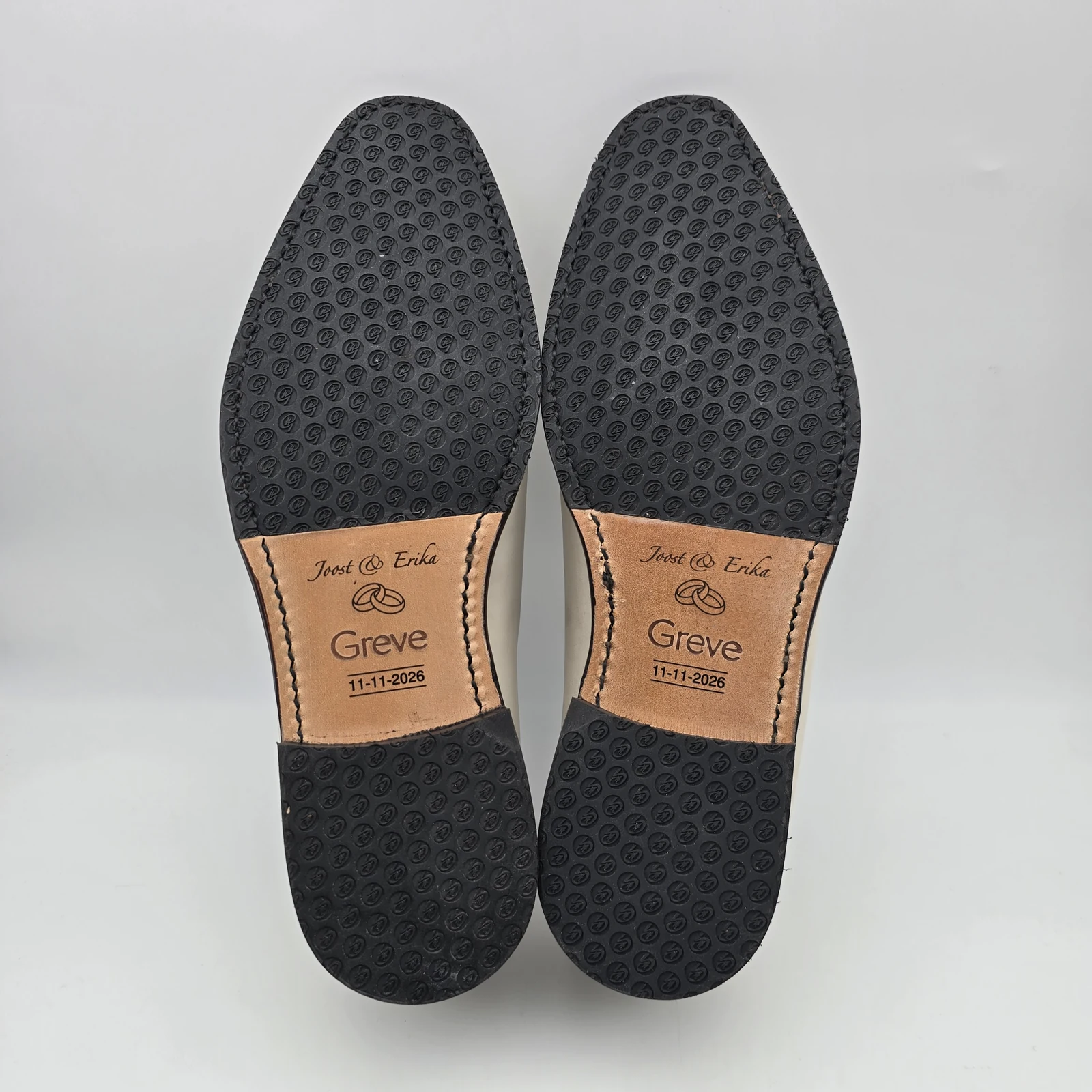 Leather sole sections engraved with Joost and Erika, wedding rings and the date 11-11-2026