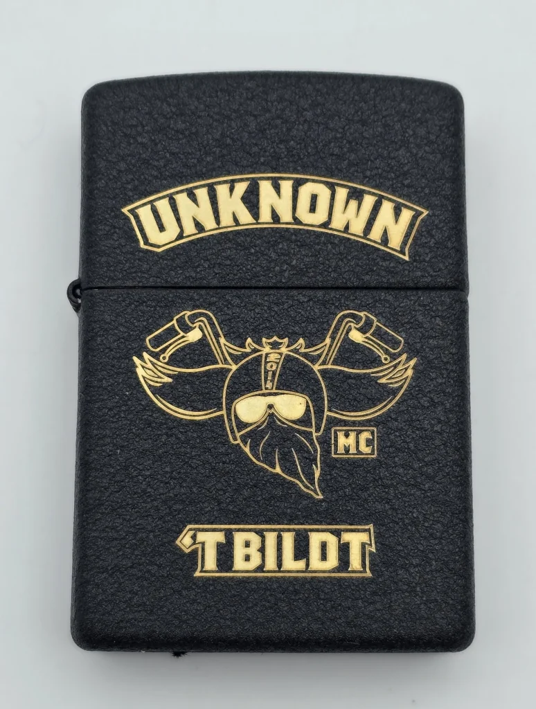 Engraved Zippo for Louise with gold-coloured motorcycle club artwork on a black textured finish